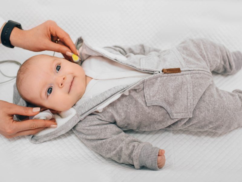 newborn child having hearing screened